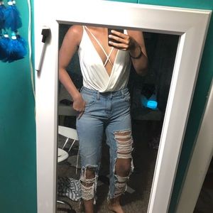 White flowy bodysuit with lines across chest